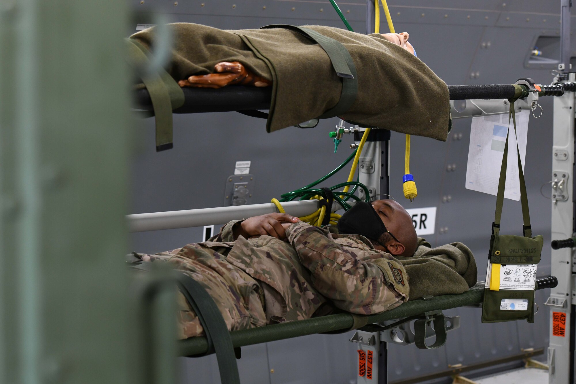 An Airman simulates being a patient