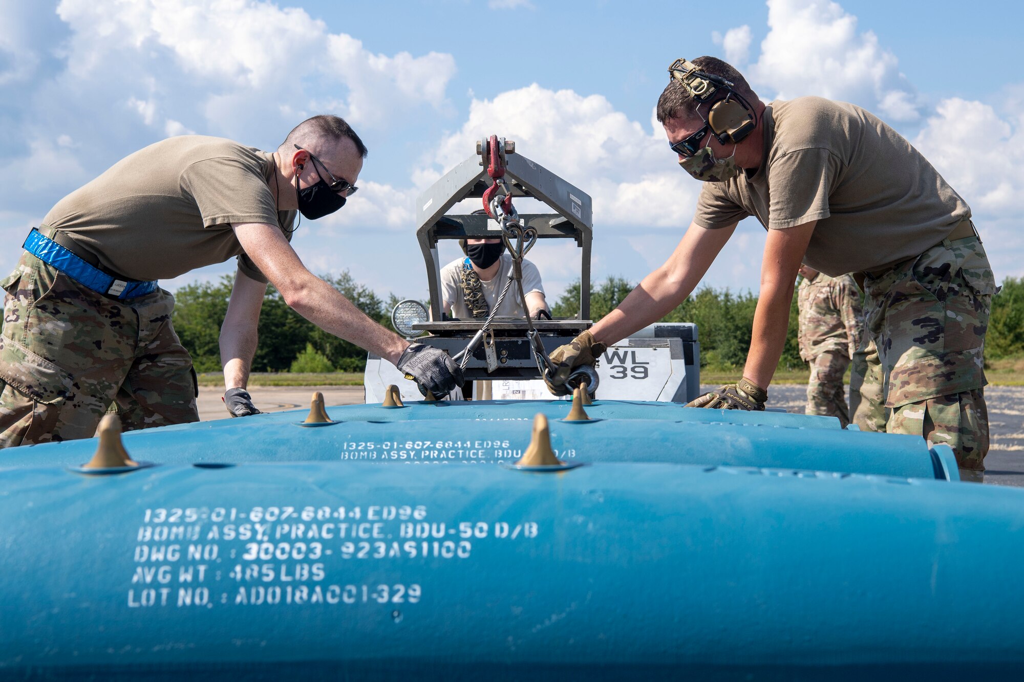 Airmen prepare to build an inert munition