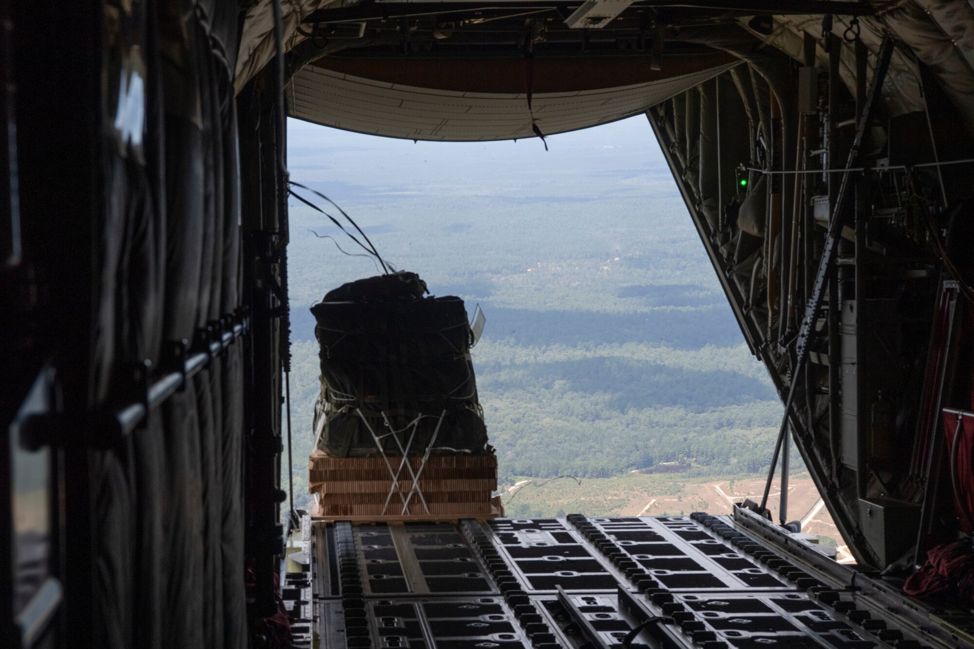 An airdrop bundle falls from an aircraft