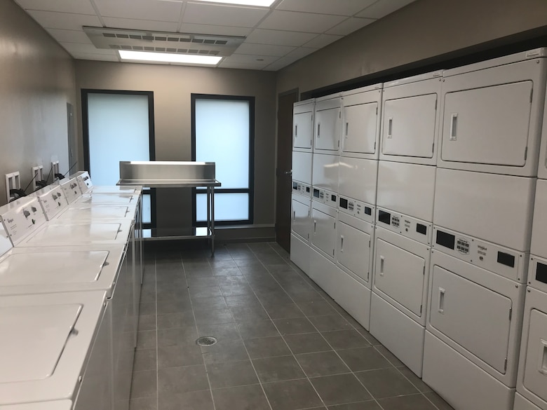 Line of laundry machines and dryers.
