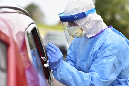 Tennessee National Guard Cpl. Samuel Ross performs a COVID-19 nasal swab at a drive-thru testing site in Cheatham County, April 3, 2020. The Guard has assisted the Department of Health in fighting COVID-19 since March.