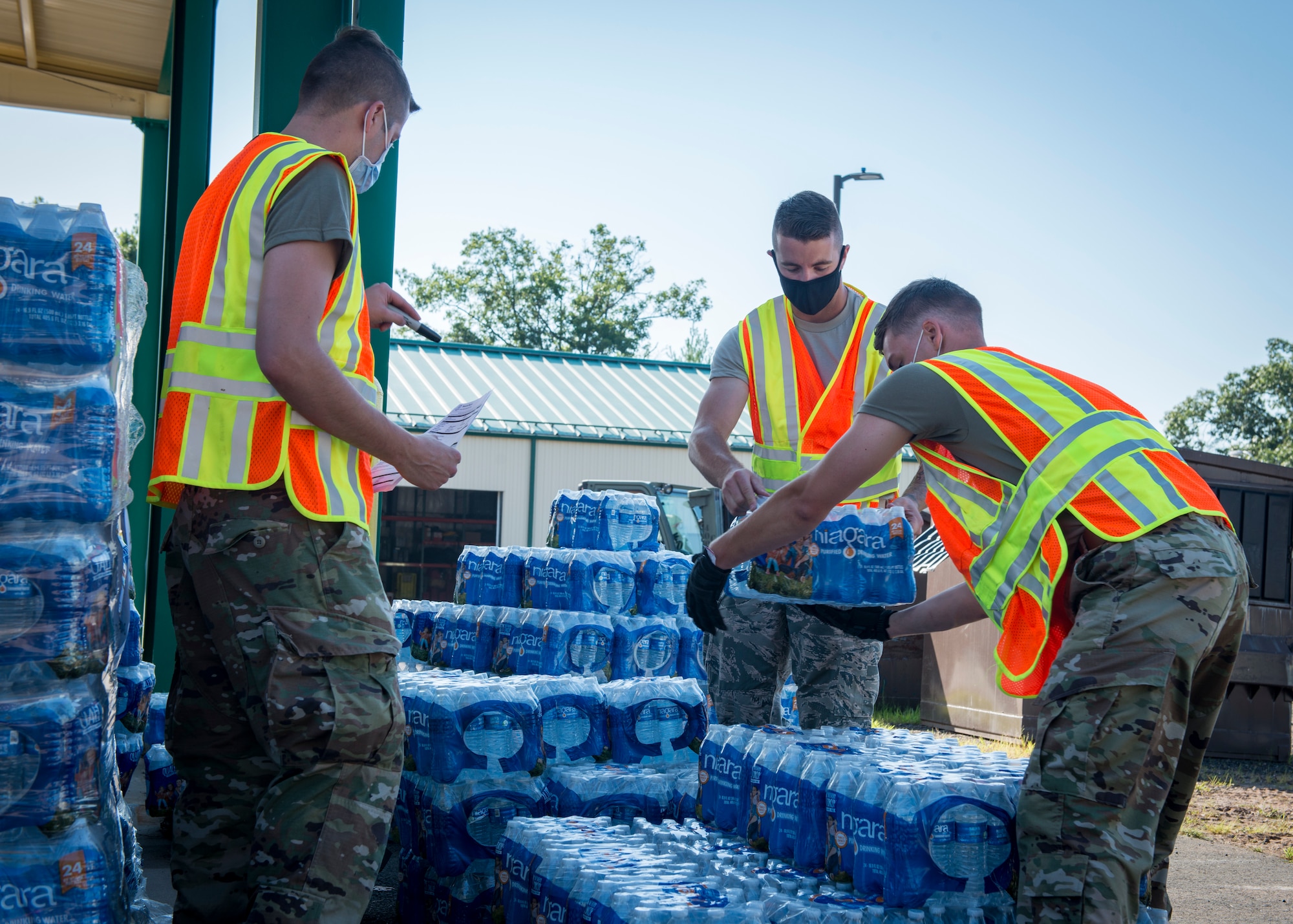 Airmen from the 103rd Airlift Wing palletize cases of water for delivery at Camp Hartell in Windsor Locks, Connecticut, Aug. 8, 2020. Soldiers and Airmen from the Connecticut National Guard delivered 21,000 cases of water from FEMA to towns throughout the state in response to Tropical Storm Isaias. (U.S. Air National Guard photo by Staff Sgt. Steven Tucker)