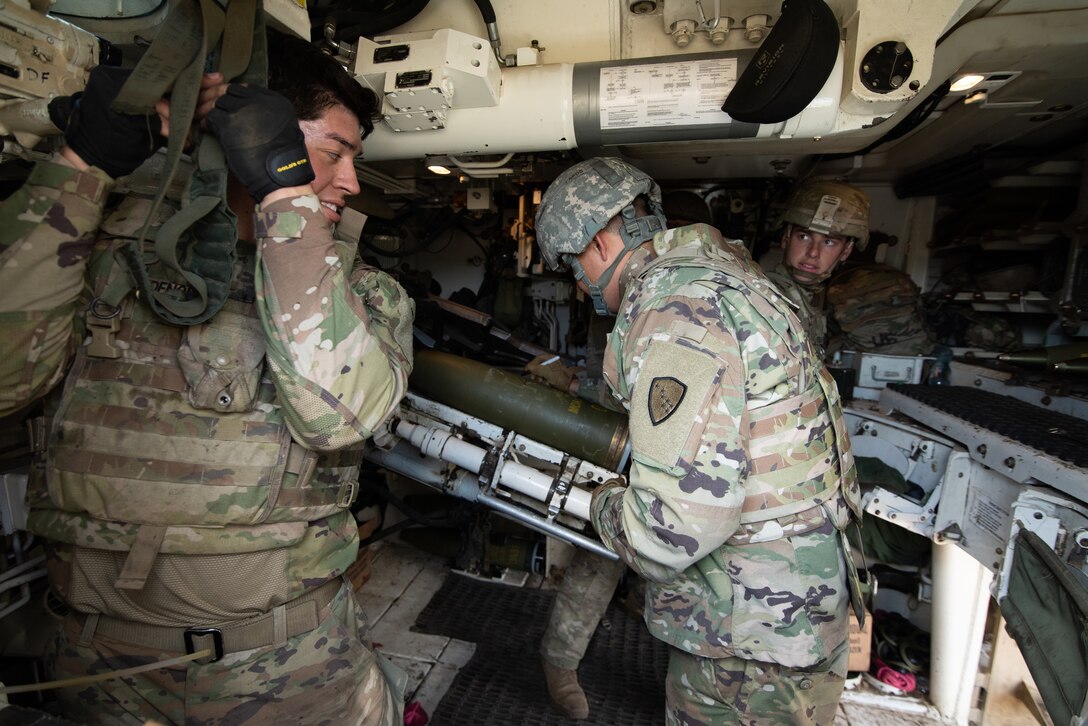 Alaska Army National Guard Specialist Drew Yeager signs a 155mm ammo round during the 1st Battalion 9th Field Artillery Regiments table certification at forward operating (FOS) site Turon, Poland, July 21,2020. Spc Yeager is a member of the FOS staff at Turon, the 1 9 FA allowed the staff to come out and learn about what Paladins capabilities were. (United States Army photo by Staff Sergeant Bethany Hendren)