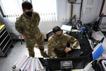 U.S. Air Force Tech. Sgt. Luis Vega and Senior Airman Carlos Lopez, cybersecurity managers with the 156th Communications Flight, Puerto Rico Air National Guard, run software programs from a workstation at Muñiz Air National Guard Base, July 7, 2020.