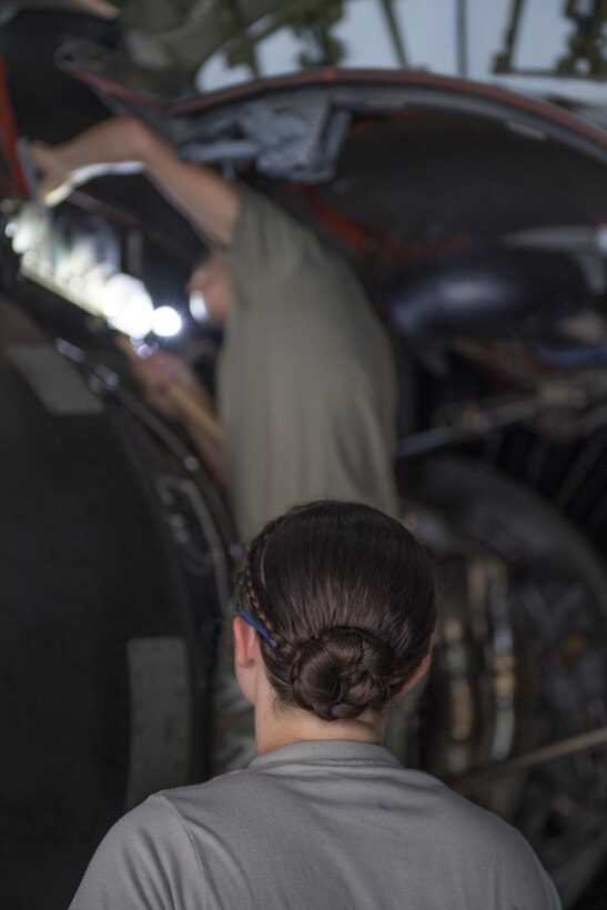 Senior Airman Natalie Rupp, aircraft structural maintenance technician with the 911th Maintenance Squadron, watches as Tech Sgt. Shelly Pavcik, aircraft structural maintenance technician with the 911th MXS, uses a hammer on a C-17 Globemaster III engine during a Home Station Check at the Pittsburgh International Airport Air Reserve Station, Pennsylvania Aug. 25, 2020.