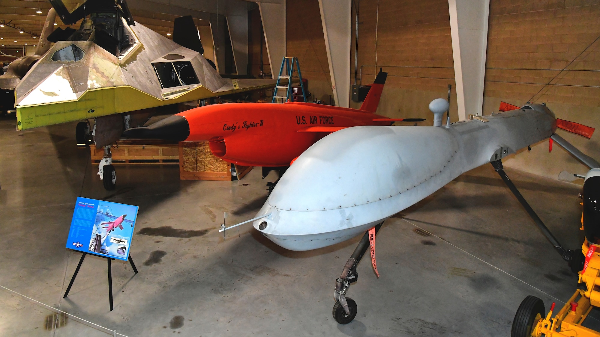 An MQ-1B Predator remotely piloted aircraft on display next to other aircraft in the Hill Aerospace Museum gallery.