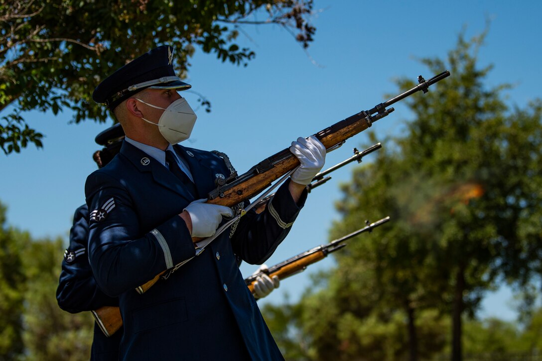 Senior Airman Kyle McLaughlin, 7th Force Support Squadron honor guardsman, leads a ceremonial firing party during a standard honors funeral at Texas State Veterans Cemetery at Abilene in Abilene, Texas, Aug. 10, 2020. Traditionally, the firing party fires three volleys. The three volleys historically represent the three shots fired from both sides that notified the completion of removing the deceased from the battlefield. (U.S. Air Force photo by Airman 1st Class Colin Hollowell)