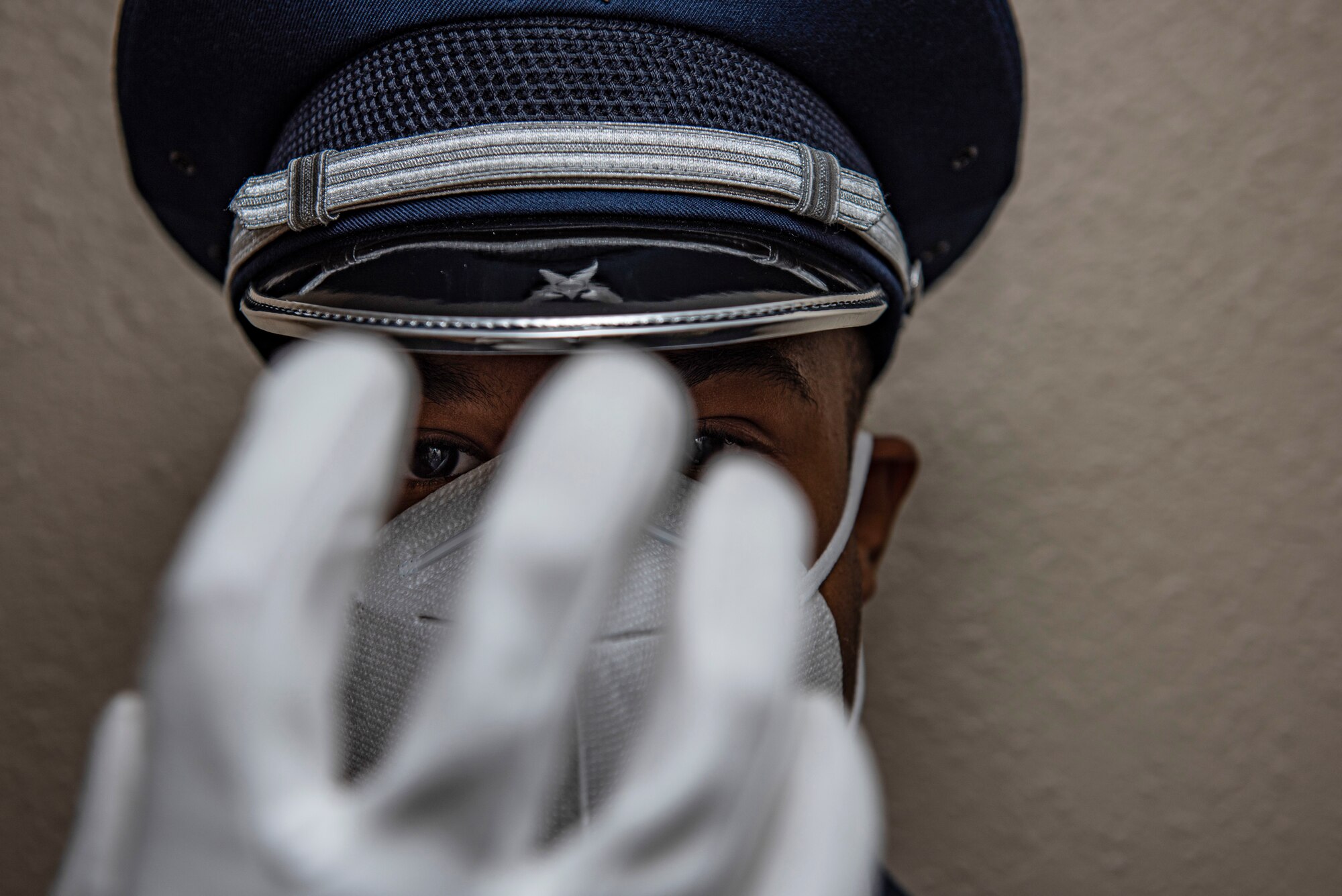 Airman 1st Class Jaidan Lanier, 7th Force Support Squadron honor guardsman, puts on a white glove at Dyess Air Force Base, Texas, Aug. 11, 2020. The honor guard provides support for military ceremonies and military funeral honors throughout 38 Texas counties including the Dallas/Fort Worth National Cemetery. (U.S. Air Force photo by Airman 1st Class Colin Hollowell)