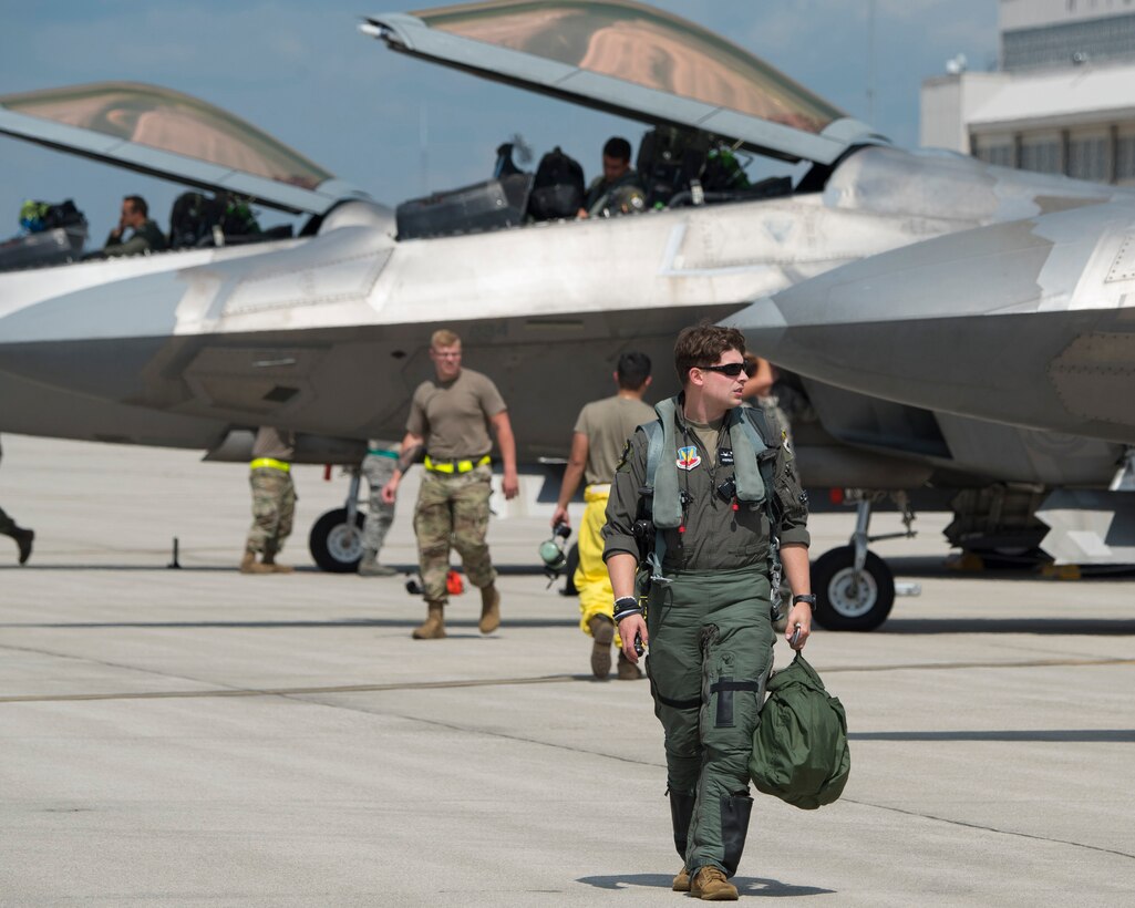 An U.S. Air Force F-22 Raptor pilot walks away from his aircraft shortly after his arrival at Wright-Patterson Air Force Base, Ohio, Aug 23, 2020. He was one of eight pilots with the 325th Fighter Squadron who flew their planes up from Eglin AFB, Fla., to protect them from Hurricane Marco and Tropical Storm Laura which are approaching the U.S. Gulf Coast. (U.S. Air Force photo by R.J. Oriez)