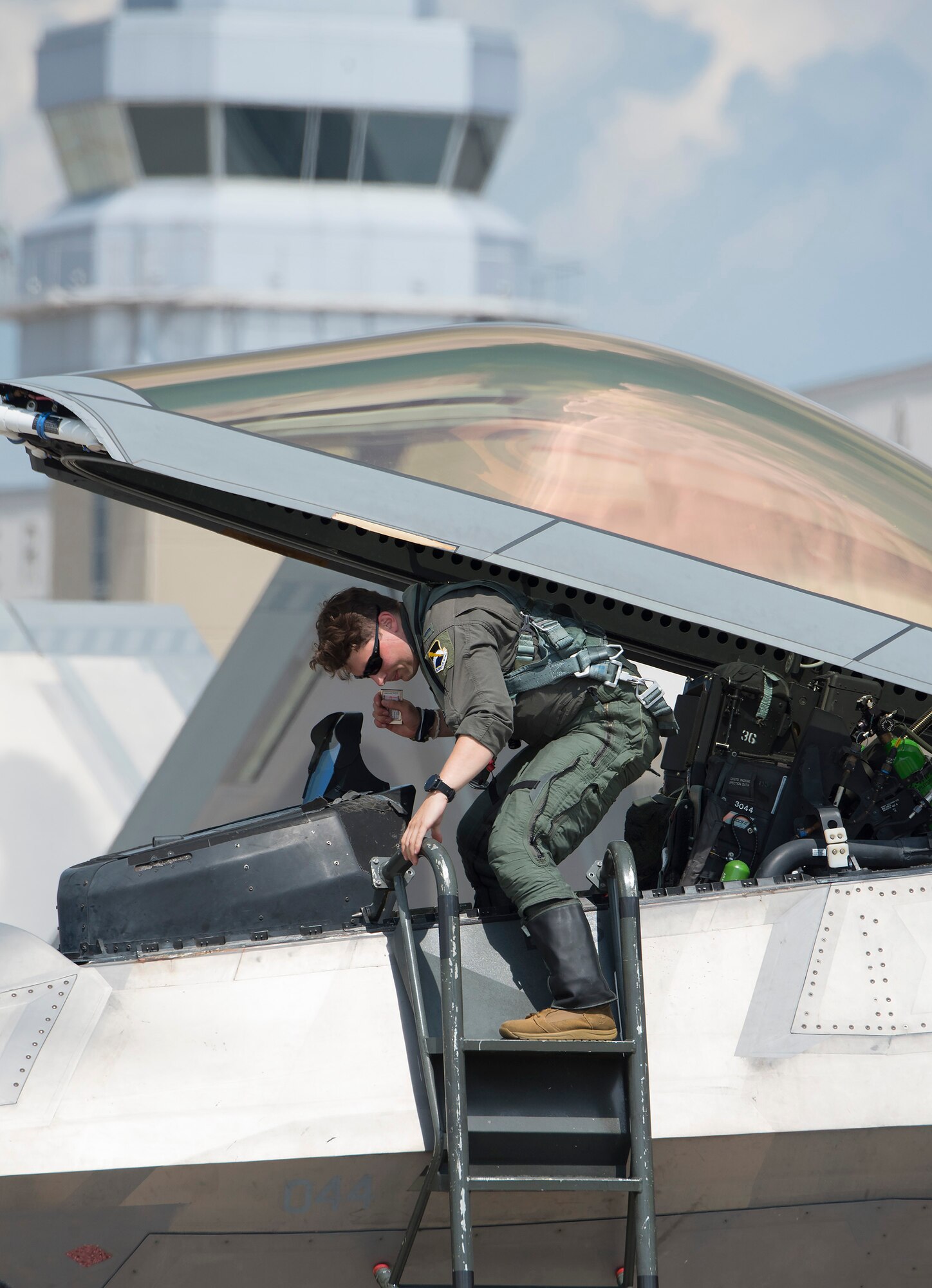 An Air Force F-22 Raptor pilot climbs out of his plane’s cockpit Aug. 23, 2020, shortly after his arrival at Wright-Patterson Air Force Base, Ohio. Eight aircraft of the 325th Fighter Wing, out of Eglin Air Force Base, Fla., flew to Wright-Patterson AFB to evade Hurricane Marco and Tropical Storm Laura which are approaching the U.S. Gulf Coast. (U.S. Air Force photo by R.J. Oriez)