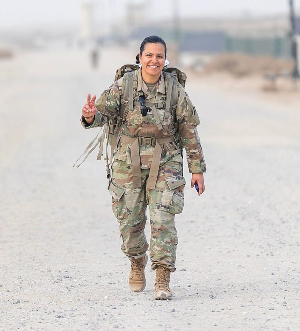 Capt. Jennifer Alvarez, company commander for the 42nd Infantry Division's Operation's Comany, does a 26.2 mile ruck march on her deployment to the Middle East March 18, 2020.