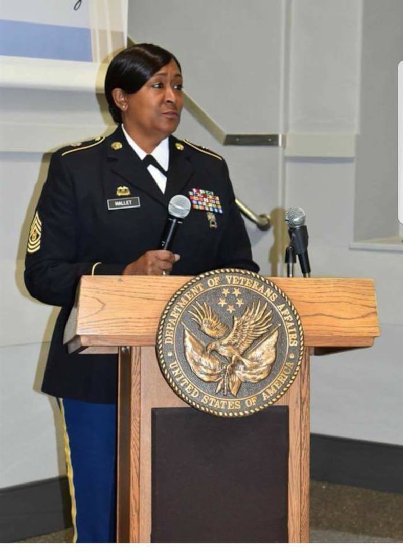 Sgt. Maj. Debora Mallet from the 42nd Infantry Division, who is the noncommissioned officer in charge for supply and services under the division's logistics section, speaks at a public event.