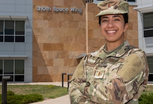 Picture of a woman standing with her arms crossed.