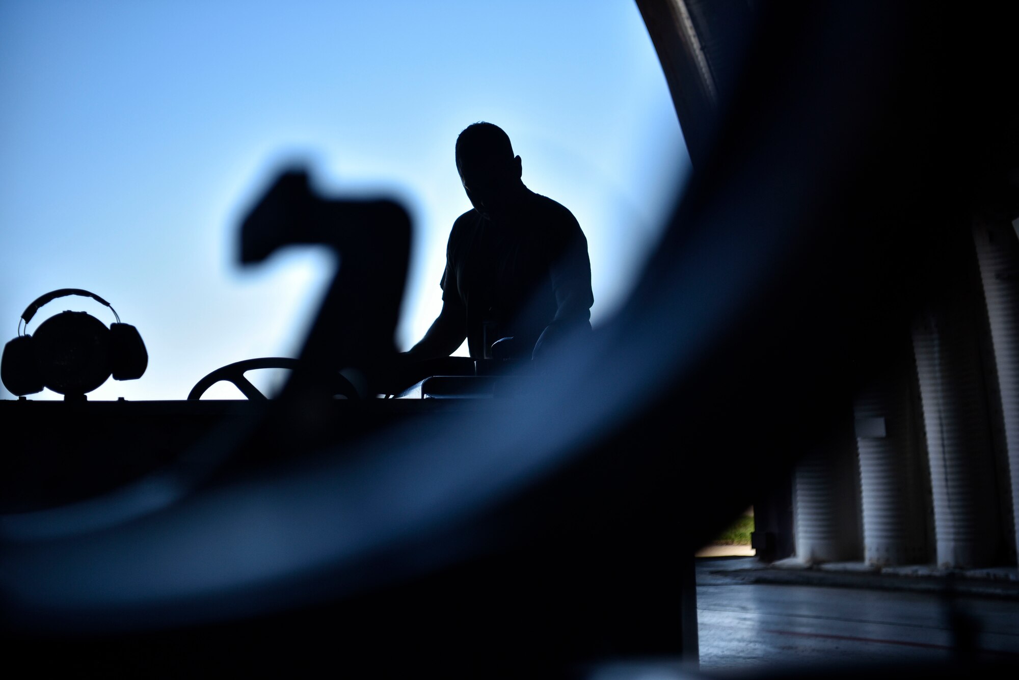A photo of an Airman observing maintenance operations.