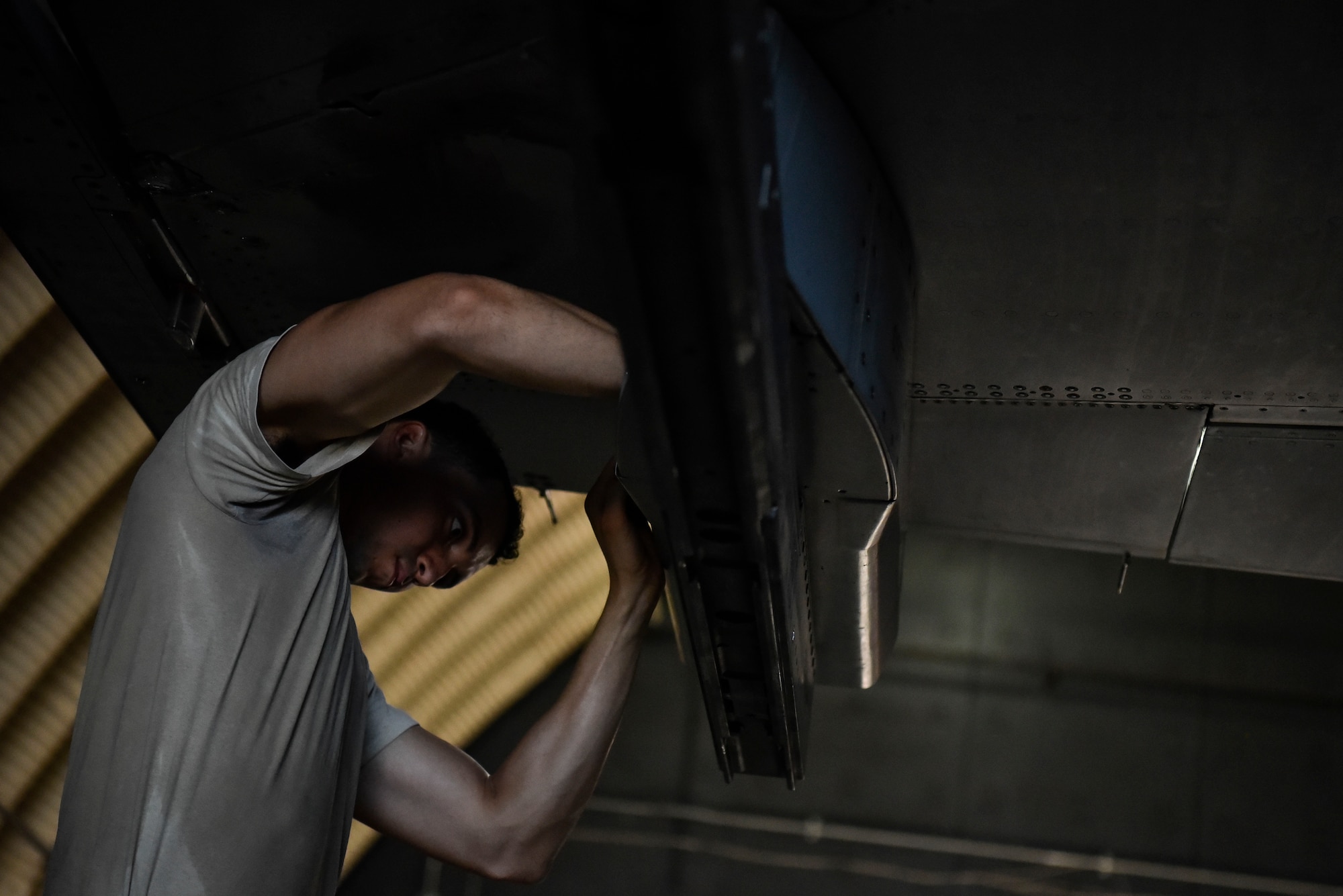A photo of an Airman tightening bolts.