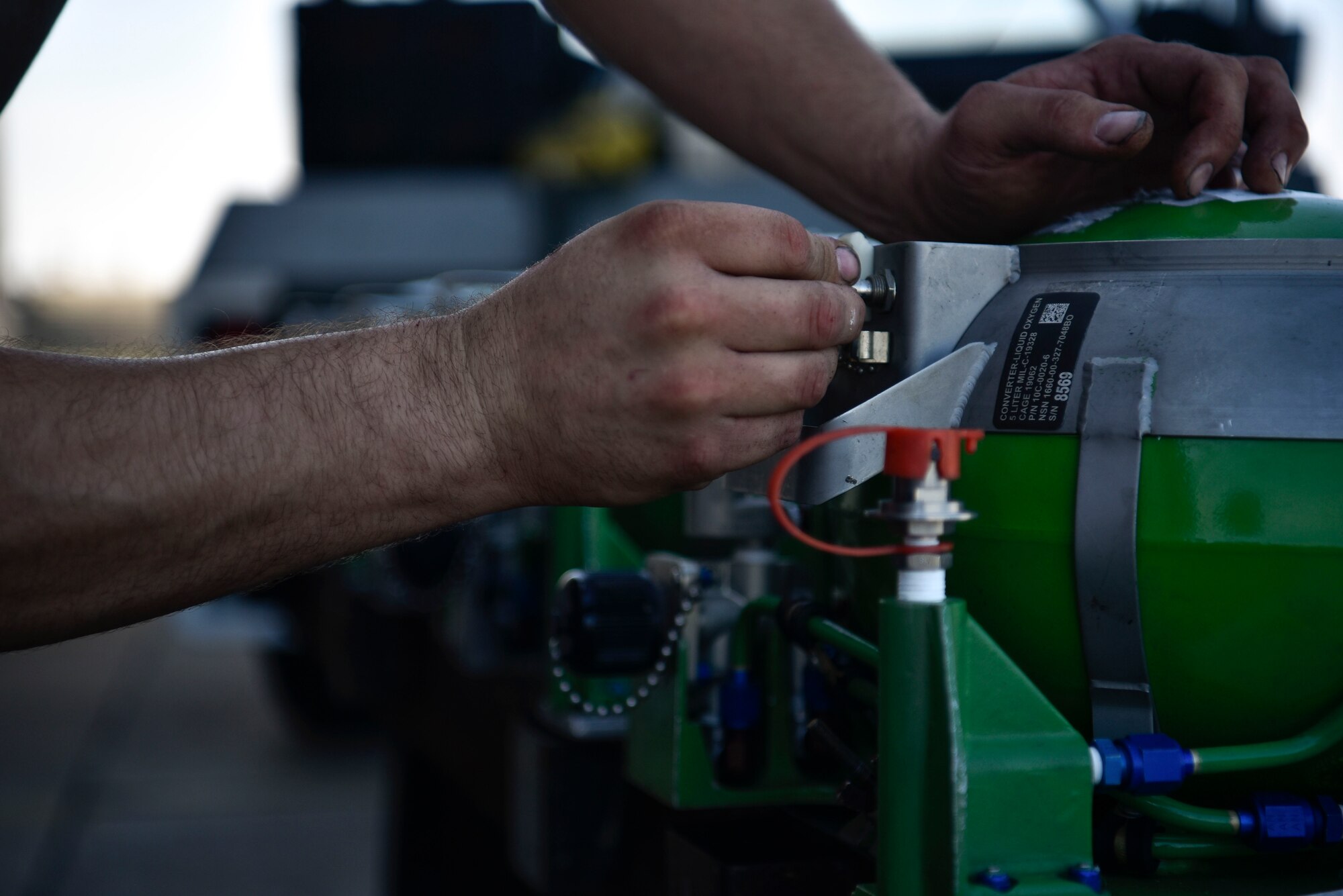 A photo of an Airman securing a liquid oxygen converter.