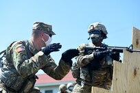 U.S. Army Reserve Sgt. 1st Class Eric Monson, left, observer coach/trainer assigned to the 1st Battalion, 383rd Regiment in Des Moines, Iowa, instructs a Soldier assigned to the 849th Quartermaster Company, Rocky Mount, North Carolina, during Table 3 of the new Army Individual Weapons Qualification standards that will take effect on October 1, 2020.