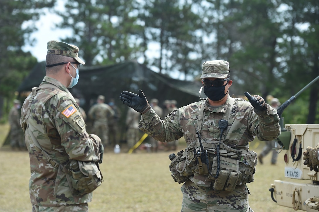 Brig. Gen. Ernest Litynski, left, commanding general of the 85th U.S. Army Reserve Support Command, meets with Chief Warrant Officer 3 Richard Begonia, an active component observer coach/trainer, assigned to 1st Battalion, 351st Regiment (Brigade Support Battalion), during Operation Ready Warrior exercise, at Fort McCoy, Wisconsin, August 22, 2020.