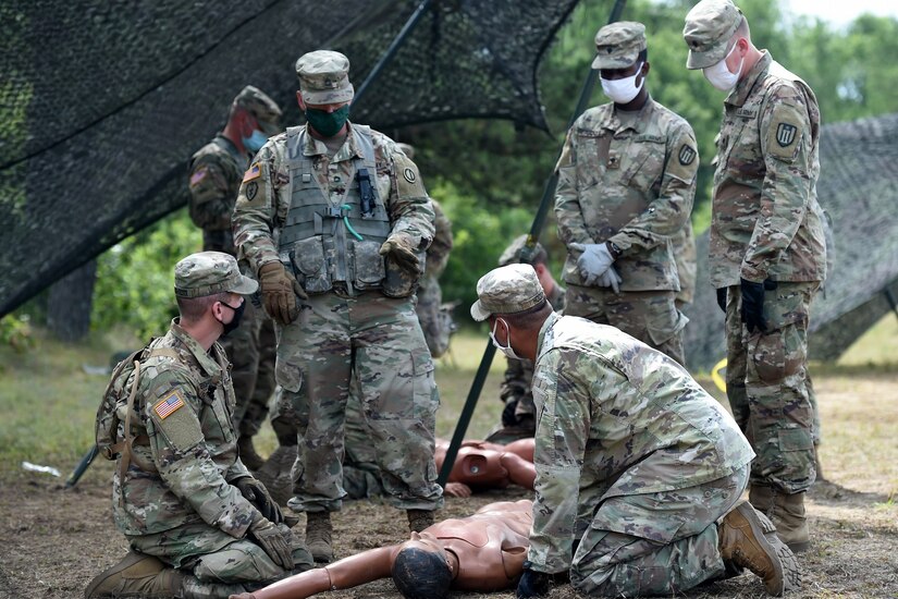 An Army Reserve observer coach/trainer assigned to the 85th U.S. Army Reserve Support Command, observes training on Performing First Aid to Open the Airway for Soldiers from the 623rd Inland Cargo Transfer Company, during Operation Ready Warrior exercise, at Fort McCoy, Wisconsin, August 22, 2020.