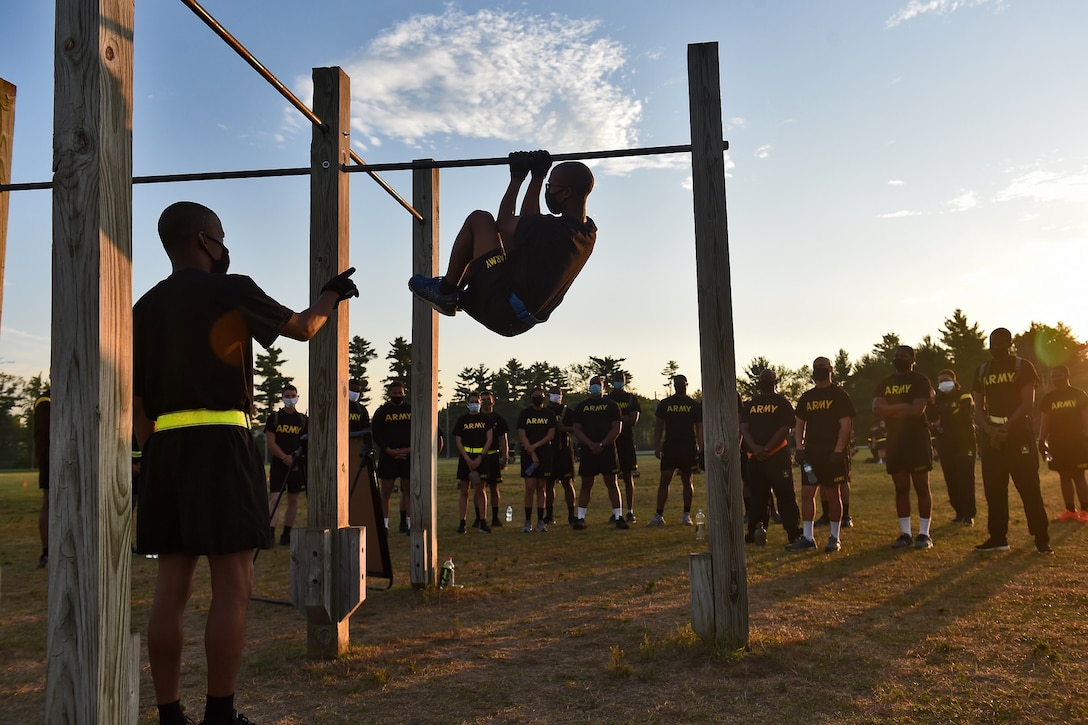Army Reserve observer coach/trainers, assigned to the 85th U.S. Army Reserve Support Command, working under First Army’s 181st Multi-functional Training Brigade, demonstrate the proper way to conduct the leg tuck, one of six test events for the Army Combat Fitness Test, during Operation Ready Warrior exercise, at Fort McCoy, Wisconsin, August 23, 2020.