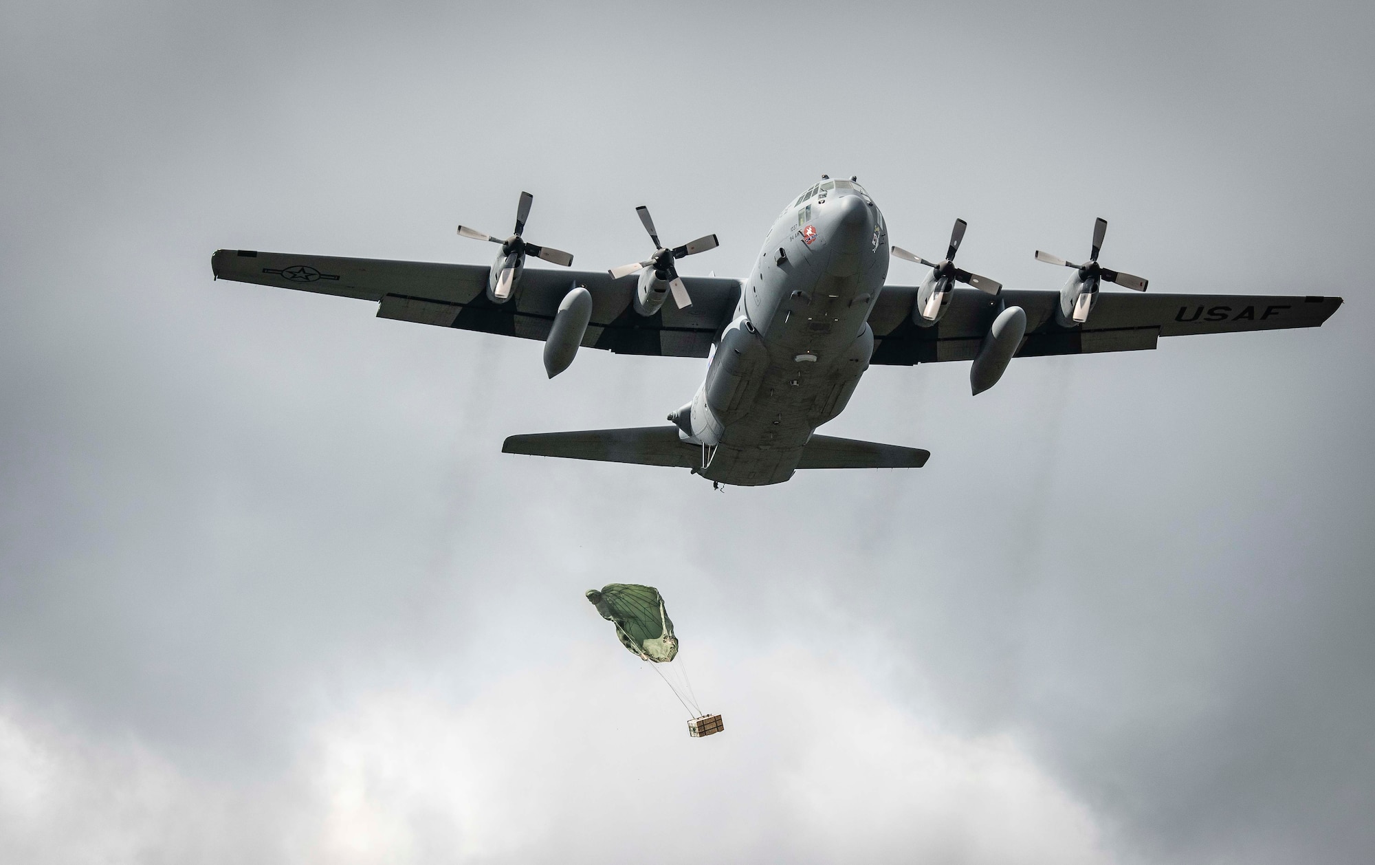 Cargo parachutes toward the drop zone as a C-130H Hercules performs an airdrop near Charleston, W. Va., Aug. 24, 2020. Eight C-130s from Reserve and Guard partners participate in a week-long training event. The scenario was designed to test the abilities of Air Force Reserve units to execute rapid global mobility missions in challenging, contested scenarios. (U.S. Air Force Reserve photo by Senior Airman Nathan Byrnes)