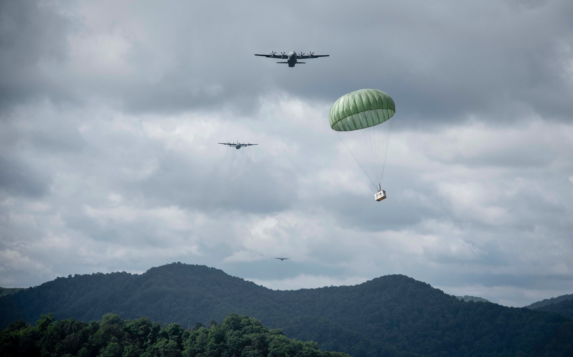 Cargo parachutes toward the drop zone as C-130 aircraft perform a formation airdrop near Charleston, W. Va., Aug. 24, 2020. Eight C-130s from Reserve and Guard partners participate in a week-long training event. The scenario was designed to test the abilities of Air Force Reserve units to execute rapid global mobility missions in challenging, contested scenarios. (U.S. Air Force Reserve photo by Senior Airman Nathan Byrnes)