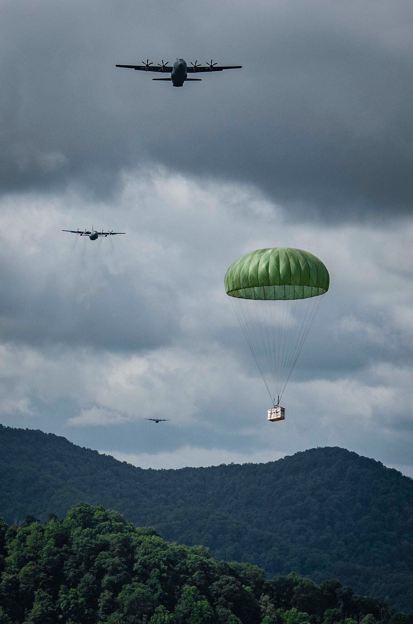 Cargo parachutes toward the drop zone as C-130 aircraft perform a formation airdrop near Charleston, W. Va., Aug. 24, 2020. Eight C-130s from Reserve and Guard partners participate in a week-long training event. The scenario was designed to test the abilities of Air Force Reserve units to execute rapid global mobility missions in challenging, contested scenarios. (U.S. Air Force Reserve photo by Senior Airman Nathan Byrnes)