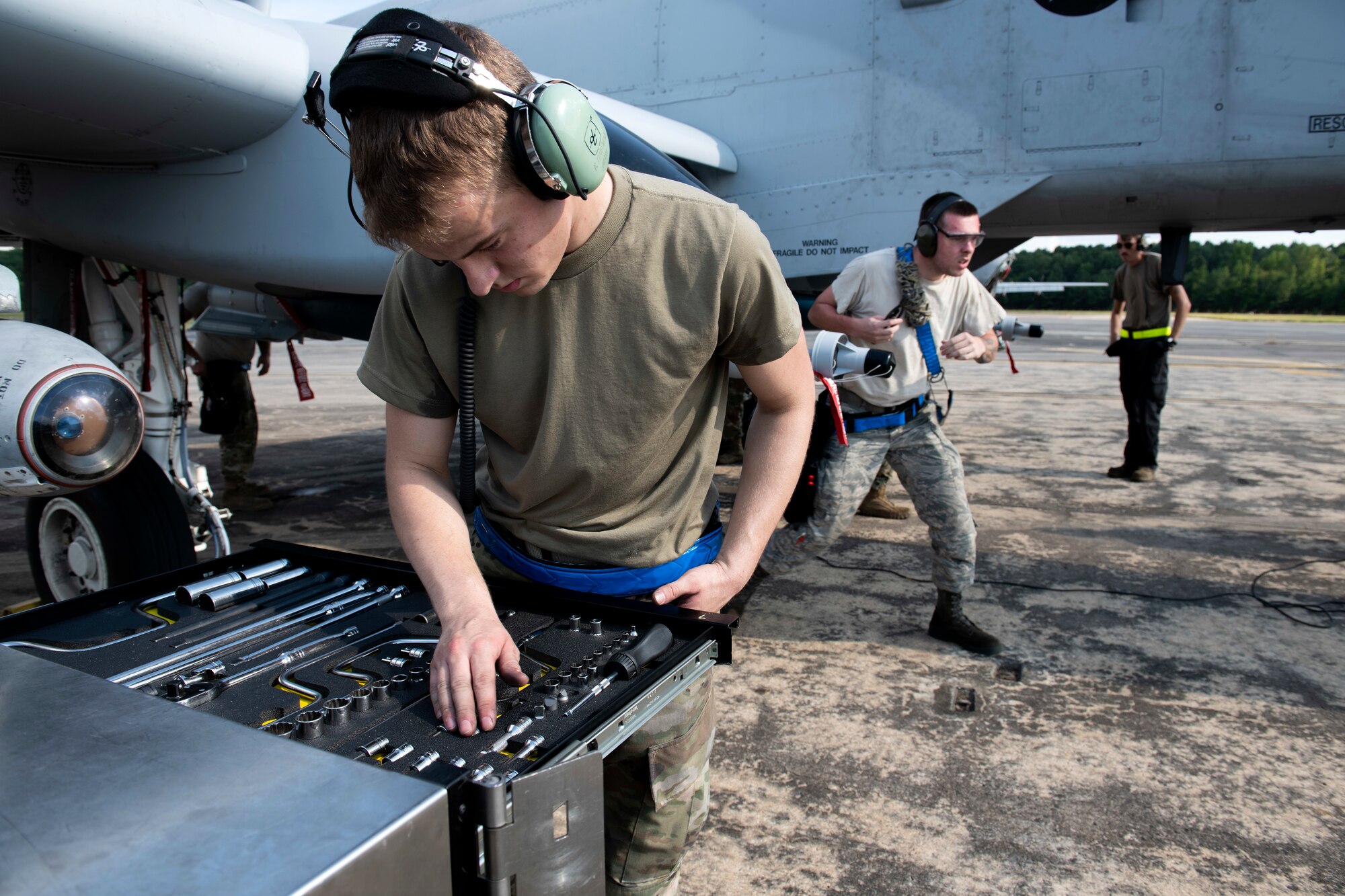 An Airman examines his tools