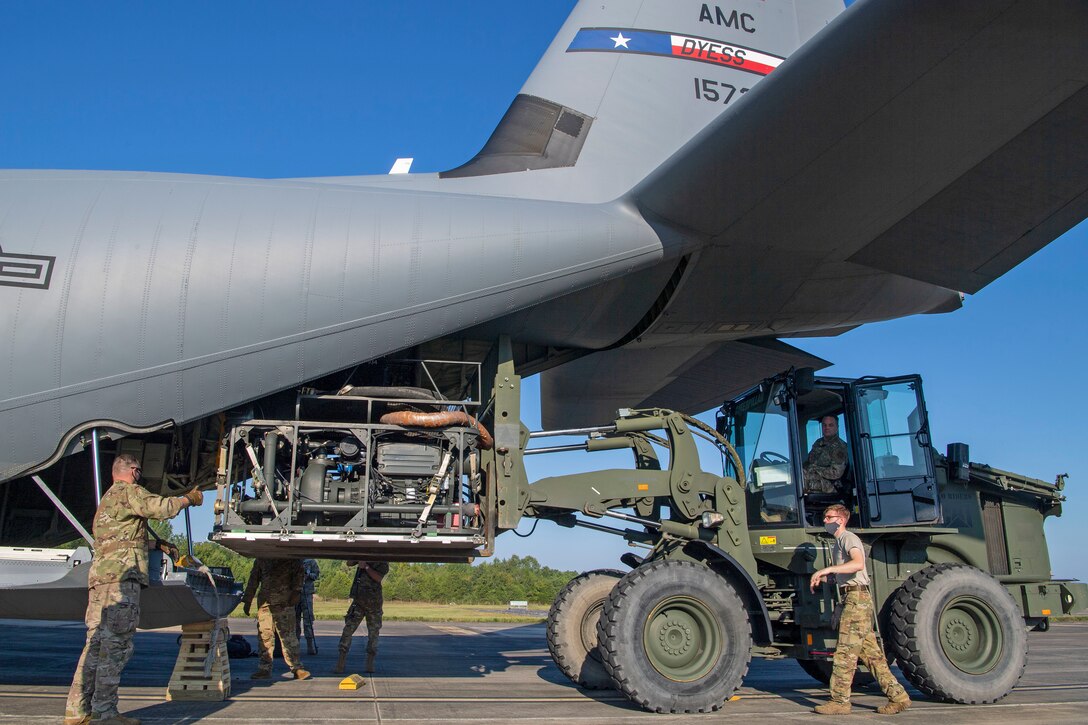 A piece of equipment is loaded onto an aircraft