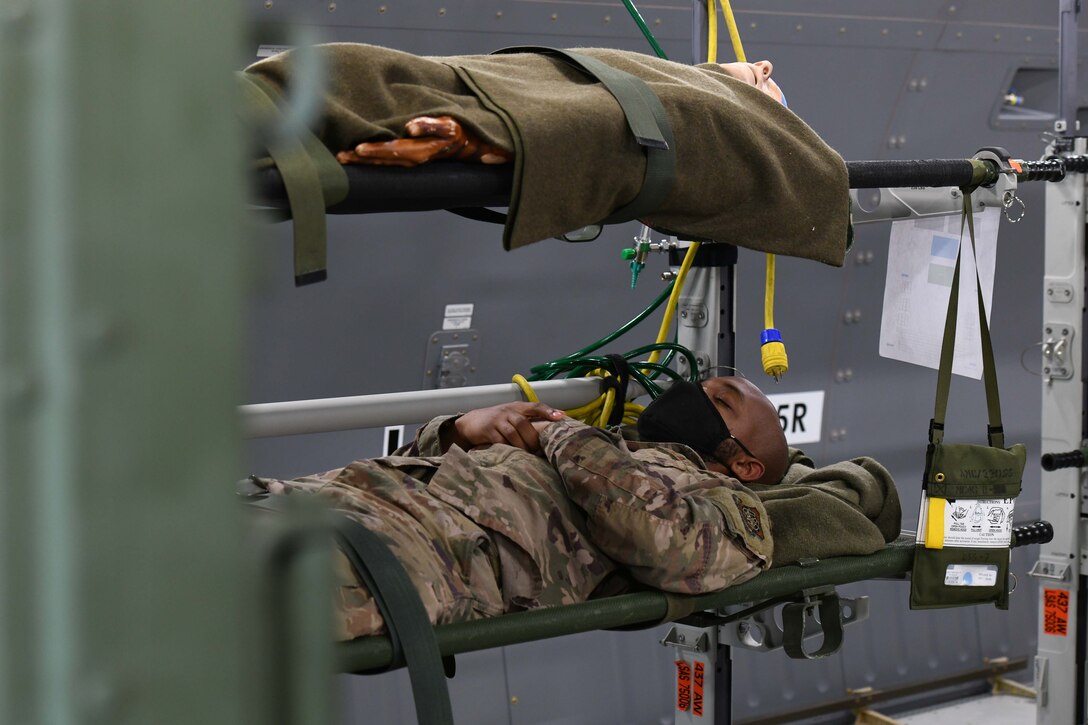 An Airman simulates being a patient