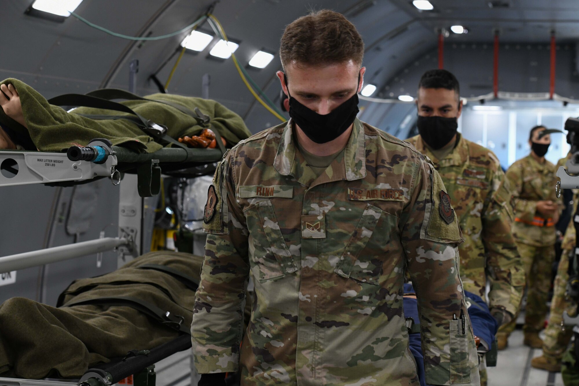 Airmen simulate moving patients within an aircraft