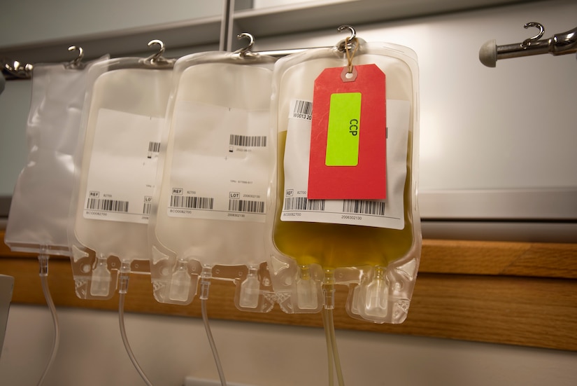 Plasma collection bags hang on a wall.