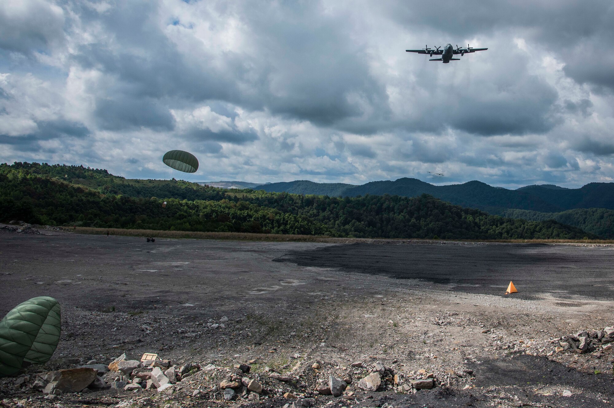 Cargo parachutes toward the drop zone as a C-130 aircraft performs an airdrop near Charleston, W. Va., Aug. 24, 2020. Eight C-130s from Reserve and Guard partners participate in a week-long training event. The scenario was designed to test the abilities of Air Force Reserve units to execute rapid global mobility missions in challenging, contested scenarios. (U.S. Air Force Reserve photo by Senior Airman Nathan Byrnes)