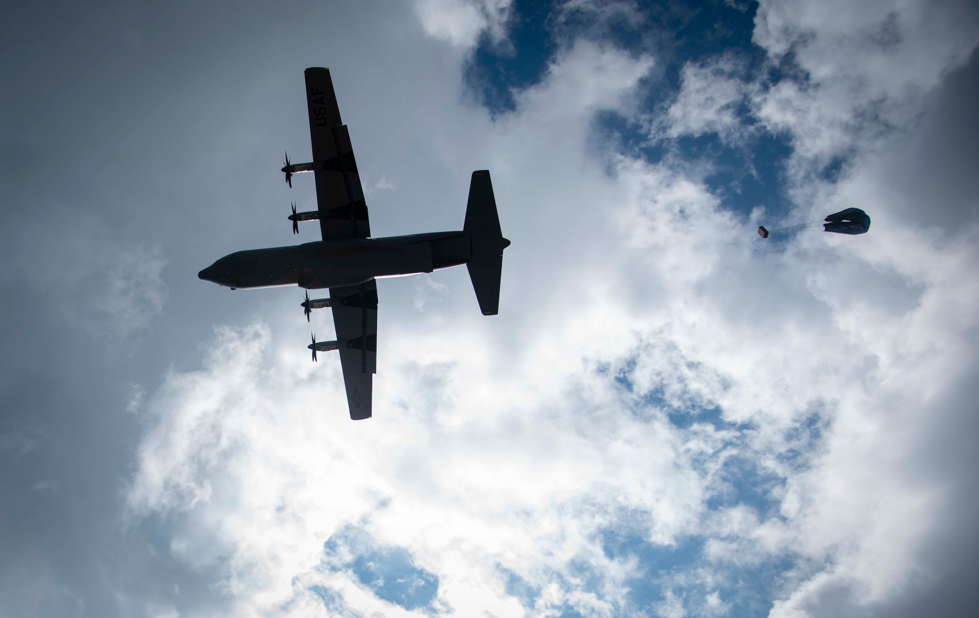 Cargo parachutes toward the drop zone as C-130 aircraft perform a formation airdrop near Charleston, W. Va., Aug. 24, 2020. Eight C-130s from Reserve and Guard partners participate in a week-long training event. The scenario was designed to test the abilities of Air Force Reserve units to execute rapid global mobility missions in challenging, contested scenarios. (U.S. Air Force Reserve photo by Senior Airman Nathan Byrnes)