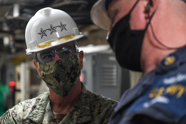 Vice Adm. Roy Kitchener, Commander, Naval Surface Force U.S. Pacific Fleet, tours the engine spaces of the dock landing ship USS Rushmore (LSD 47), with Senior Chief Engineman Jason Saffa.