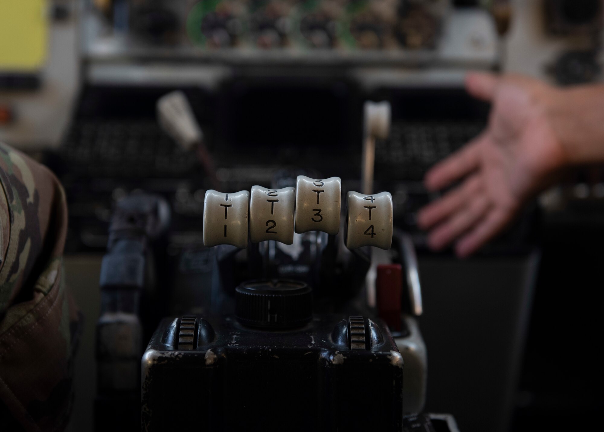 A closeup of KC-135 Stratotanker cockpit flight controls and two Airmen discussing its operation August 17, 2020.