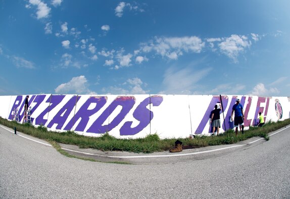 Airmen from the 510th Fighter Squadron and the 510th Aircraft Maintenance Unit paint a wall at Aviano Air Base, Italy, Aug. 13, 2020. Repainting the wall was part of the Buzzard Unity event which aimed to  boost morale and camaraderie.  (U.S. Air Force photo by Senior Airman Caleb House)