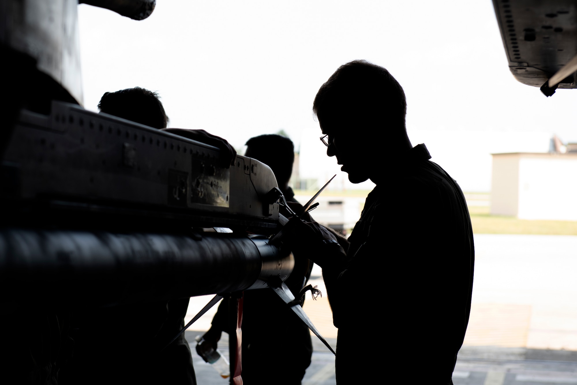 A pilot from the 510th Fighter Squadron takes notes while maintenance Airmen explain the upkeep process of an F-16 Fighting Falcon at Aviano Air Base, Italy, Aug. 13, 2020. The 510th FS and 510th Aircraft Maintenance Unit joined together for a Buzzard Unity event to bolster their working relationship. (U.S. Air Force photo by Senior Airman Caleb House)