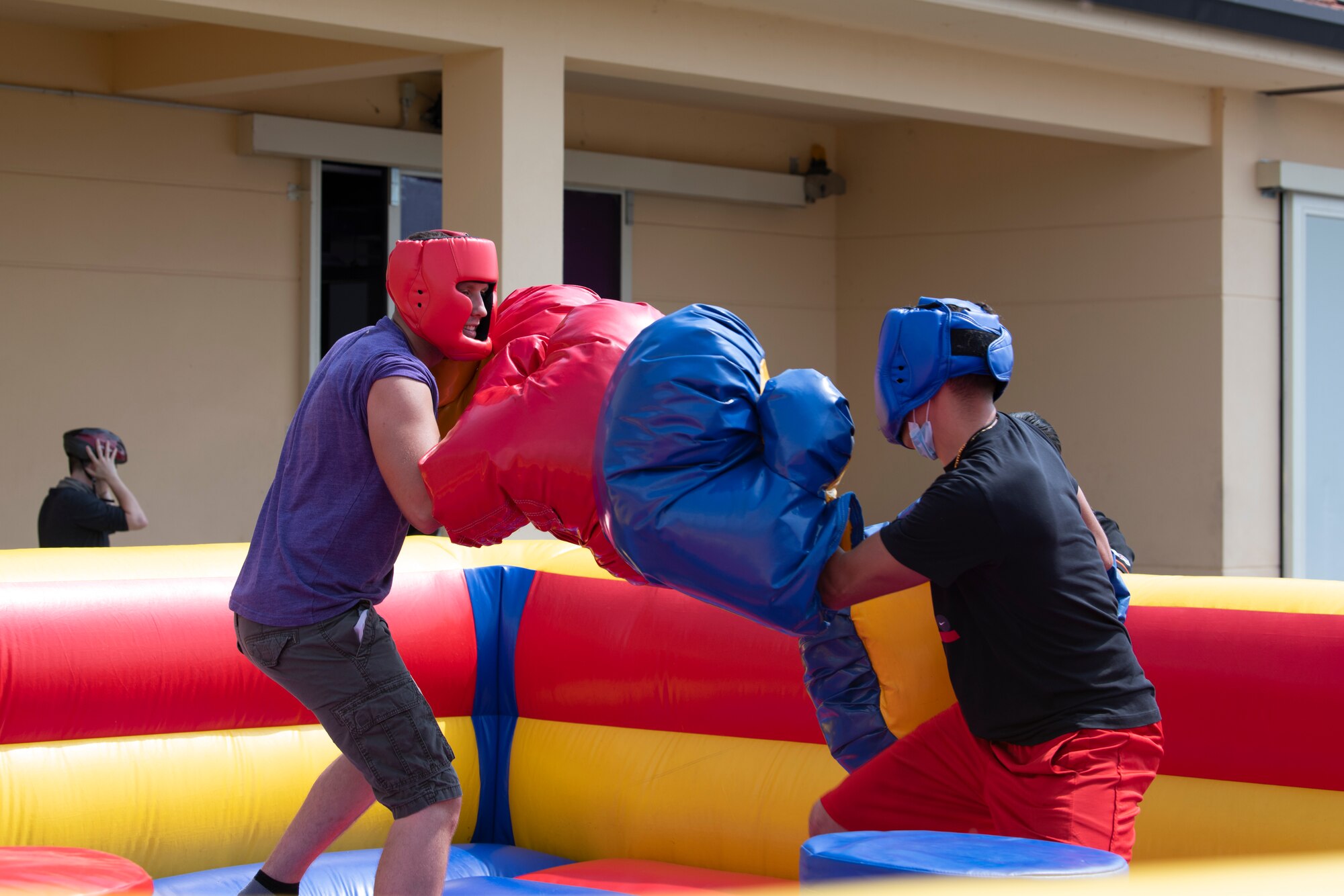 Airmen participate in an inflatable boxing match during a Buzzard Unity event at Aviano Air Base, Italy, Aug. 14, 2020. Airmen from the 510th Fighter Squadron and 510th Aircraft Maintenance Squadron came together for a two-day event to build morale and improve their working relationships. (U.S. Air Force photo by Senior Airman Caleb House)