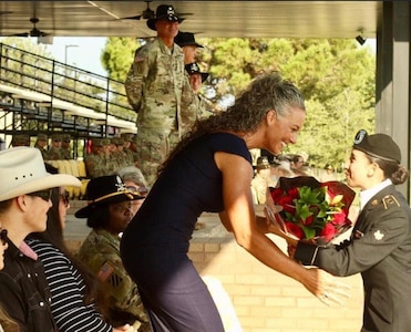 Woman receives flowers from Soldier