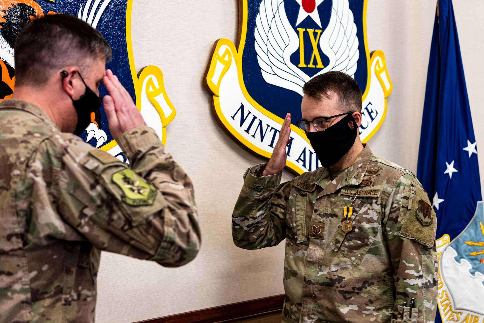 Photo of Airman saluting a commander.