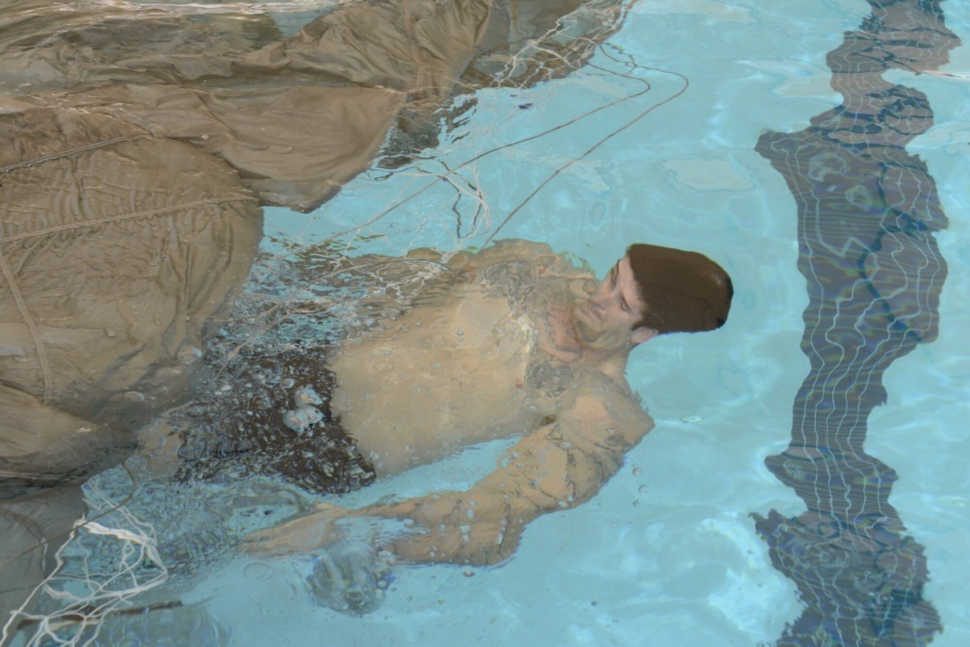 image of A Special Tactics operator resurfacing the water during wet silk training,