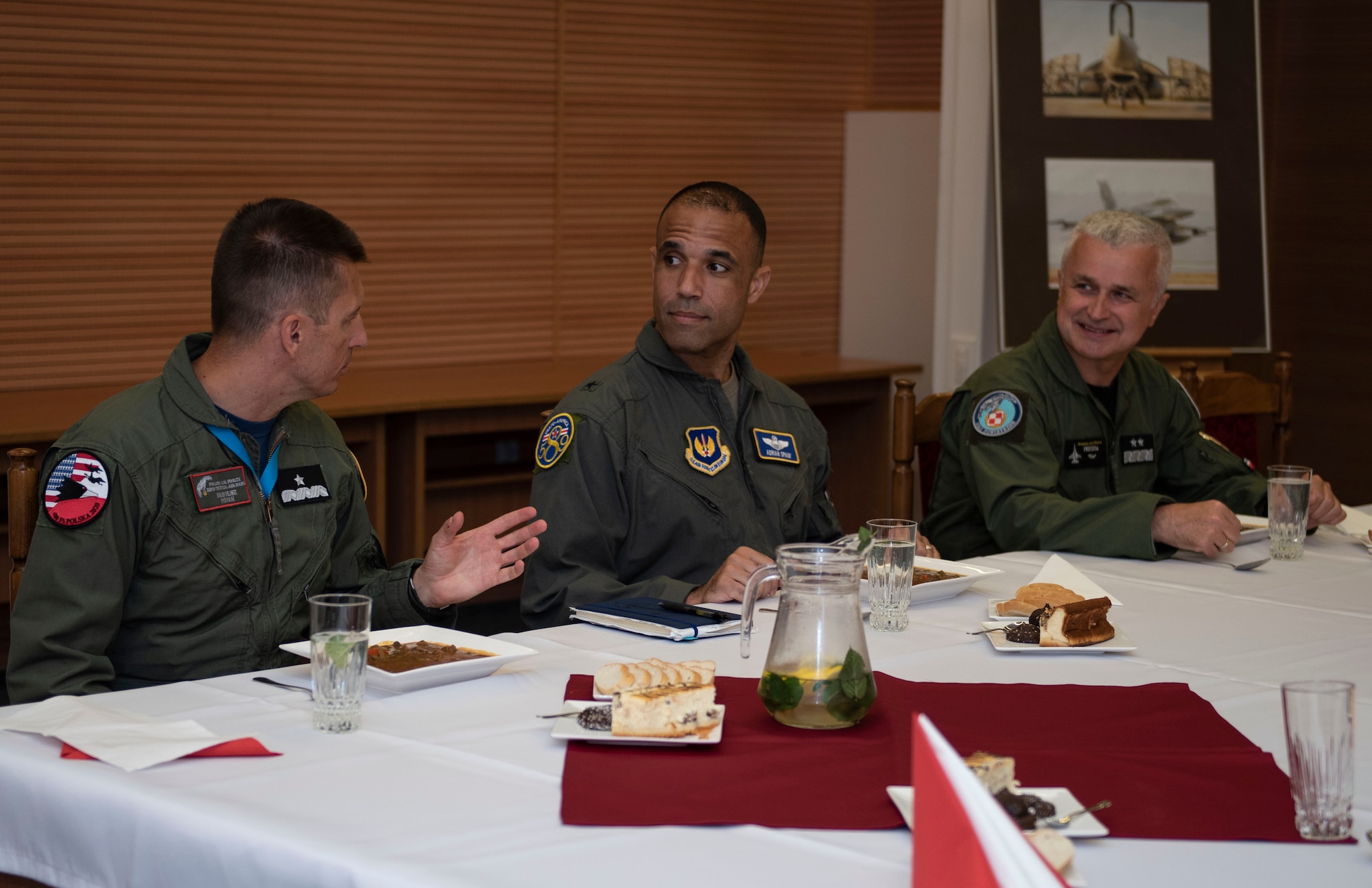 Starting far left, Polish air force Brig. Gen. Iteneusz Nowak, 2nd Tactical Air Wing commander, U.S. Air Force Brig. Gen. Adrian Spain, United States Air Forces in Europe and Air Forces Africa director of plans, programs and analyses, and Polish air force Maj. Gen. Jacek Pszczoła, inspector of the Polish air force, sit down for a meal, August 24, 2020, at Łask AB, Poland. The U.S. rotational military presence in Poland contributes security in the region and immense training that cannot be done without this partnership. (U.S. Air Force photo by Senior Airman Melody W. Howley)