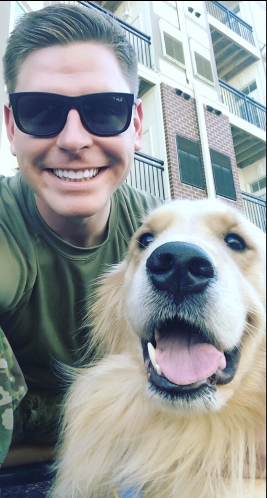 A man with sunglasses and a dog.