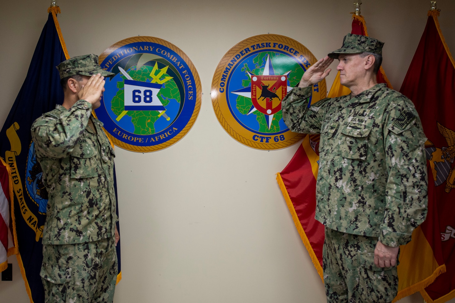 NAVAL STATION ROTA, Spain, (Aug. 26, 2020) Capt. Curt Larson, commander, Task Force (CTF) 68, right, salutes Capt. Cameron Chen during a change of command ceremony at Naval Station Rota, Spain, Aug. 26, 2020. Chen relieved Larson as commodore of CTF 68. CTF 68 provides explosive ordnance disposal operations, naval construction, expeditionary security, and theater security efforts in the U.S. 6th Fleet area of responsibility.
