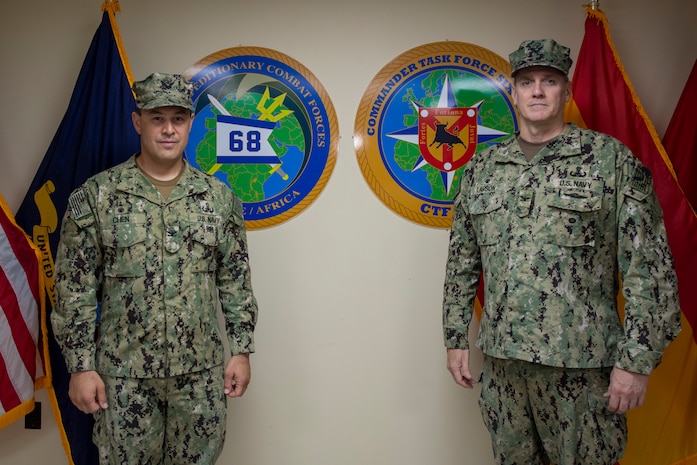 NAVAL STATION ROTA, Spain, (Aug. 26, 2020) Capt. Curt Larson, commander, Task Force (CTF) 68, right, poses for a photo with Capt. Cameron Chen during a change of command ceremony at Naval Station Rota, Spain, Aug. 26, 2020. Chen relieved Larson as commodore of CTF 68. CTF 68 provides explosive ordnance disposal operations, naval construction, expeditionary security, and theater security efforts in the U.S. 6th Fleet area of responsibility.