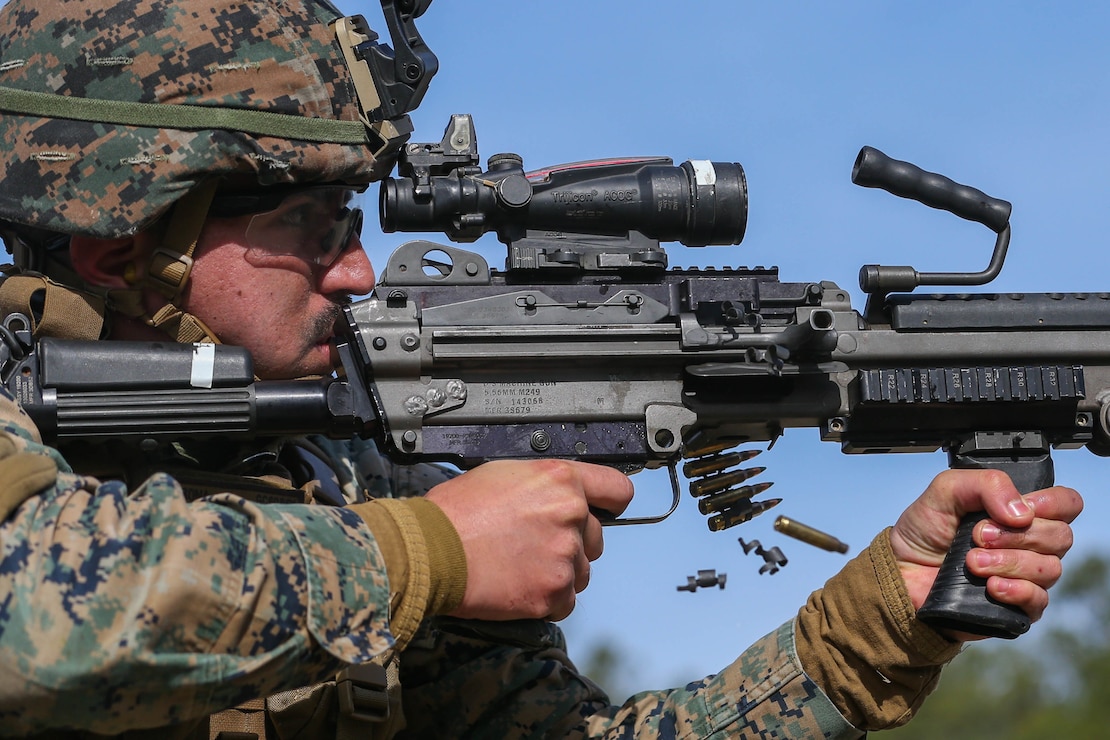 U.S. Marine Corps Sgt. Gilbert Corona, a data assistance administrator with 2nd Law Enforcement Battalion (2nd LE Bn.), II Marine Expeditionary Force Information Group, engages his target during a live-fire drill with an M249 light machine gun during a cold weather familiarization training exercise at Camp Lejeune, N.C., Jan. 21, 2020. During this training, 2nd LE Bn. conducted mounted and dismounted patrols, a weighted movement and live-fire training. (U.S. Marine Corps photo by Cpl. Stephen Campbell)