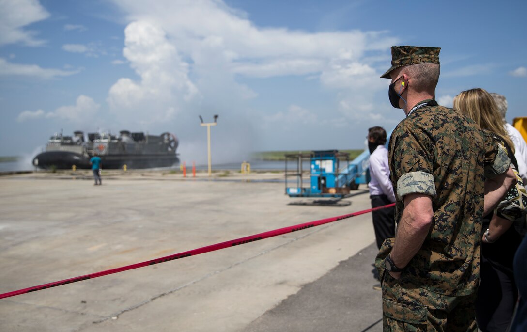 Assistant Commandant of the Marine Corps Gen. Gary L. Thomas watches a Landing Craft Air Cushion come ashore during a tour of the Textron Marine and Land Systems Shipyard in New Orleans, Aug. 11, 2020. Thomas toured the shipyards to assess capabilities and production of multiple Navy and Marine Corps projects during the novel Coronavirus pandemic. (U.S. Marine Corps photo by Sgt. Wesley Timm)