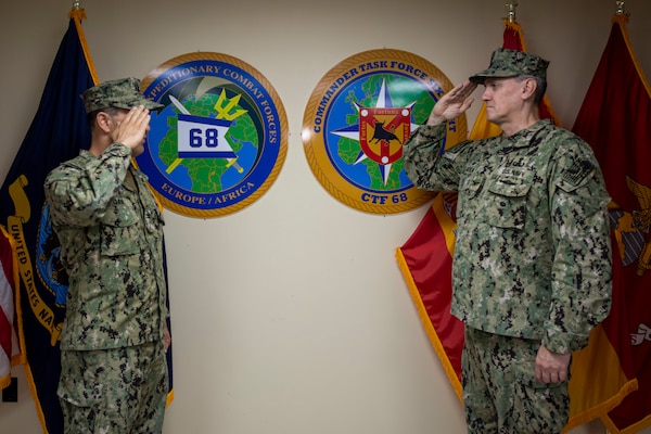 NAVAL STATION ROTA, Spain, (Aug. 26, 2020) Capt. Curt Larson, commander, Task Force (CTF) 68, right, salutes Capt. Cameron Chen during a change of command ceremony at Naval Station Rota, Spain, Aug. 26, 2020. Chen relieved Larson as commodore of CTF 68. CTF 68 provides explosive ordnance disposal operations, naval construction, expeditionary security, and theater security efforts in the U.S. 6th Fleet area of responsibility.