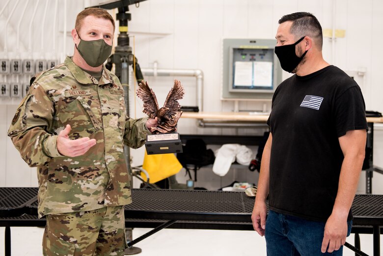 U.S. Air Force Col. Jeffrey Holland, 509th Maintenance Group commander, left, presents the Lt. Gen. Leo Marquez Award to Brent Duckworth, 509th MXG aircraft low observable structural maintenance technician, right, at Whiteman Air Force Base, Missouri, Aug. 14, 2020. Duckworth won the award in the Civilian Technician Aircraft Maintenance Category. This award recognizes military and civil service aircraft, munitions, and missile maintenance personnel who perform hands-on maintenance or manage a maintenance function. (U.S. Air Force photo by Airman 1st Class Christina Carter)